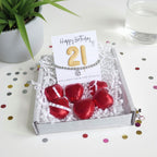 AyeDoGifts 21st birthday gift hamper with silver beaded bracelet, cubic zirconia charm, gold '21' balloons and red chocolate hearts.