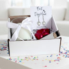 AyeDoGifts hamper for dog mums: silver heart earrings, vanilla candle, milk chocolate hearts, and matches.