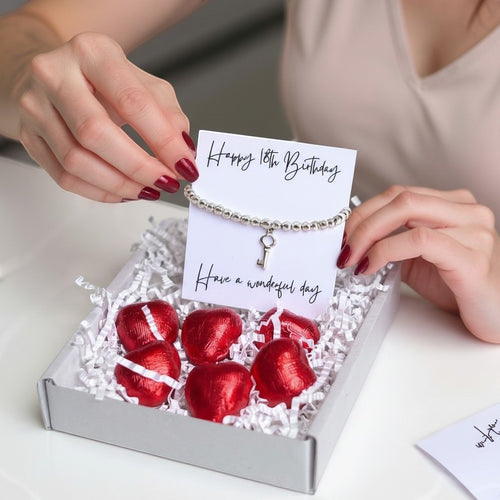 AyeDoGifts 18th birthday gift hamper with silver beaded bracelet, key charm, message card and red foiled chocolate hearts.