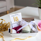 AyeDoGifts 18th birthday hamper with gold balloon card, silver bracelet, vanilla candle, matches and chocolates.