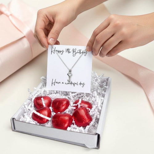 AyeDoGifts 18th birthday gift hamper with sterling silver key necklace and red foiled chocolate hearts.