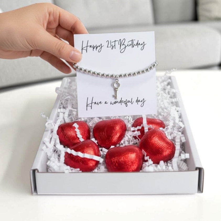 AyeDoGifts 21st birthday gift hamper with silver beaded bracelet, key charm, message card and red foiled chocolate hearts.