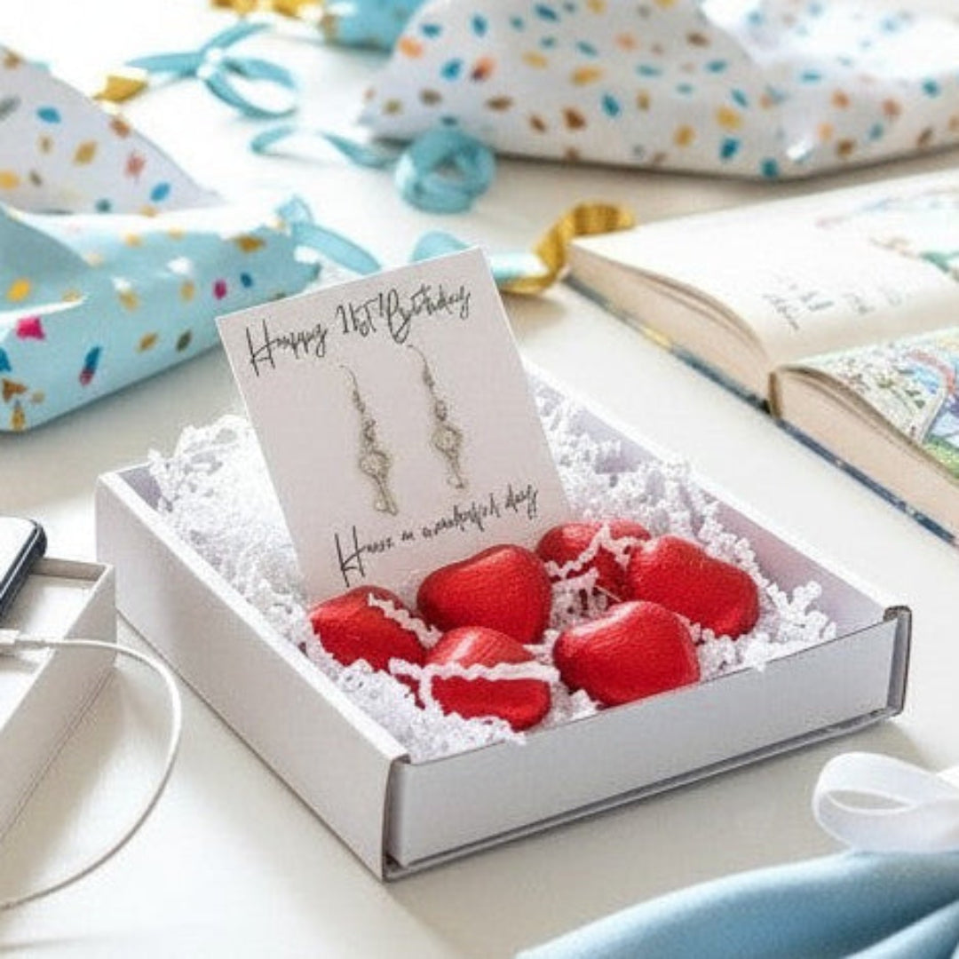 AyeDoGifts 21st birthday gift hamper with key charm earrings, milk chocolate hearts, and a message card.