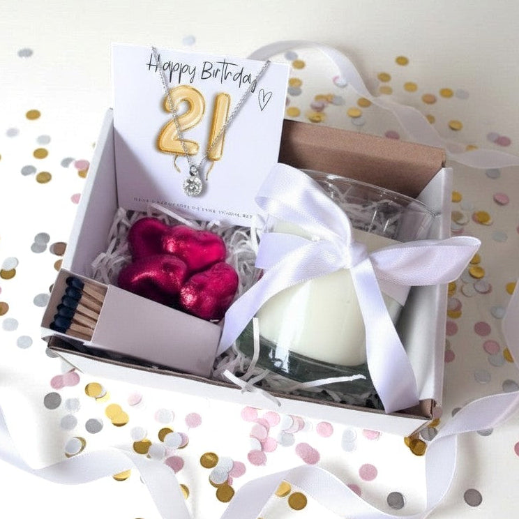 AyeDoGifts 21st birthday hamper with gold number 21 balloons, sterling silver necklace, vanilla candle, matches, and chocolate hearts.