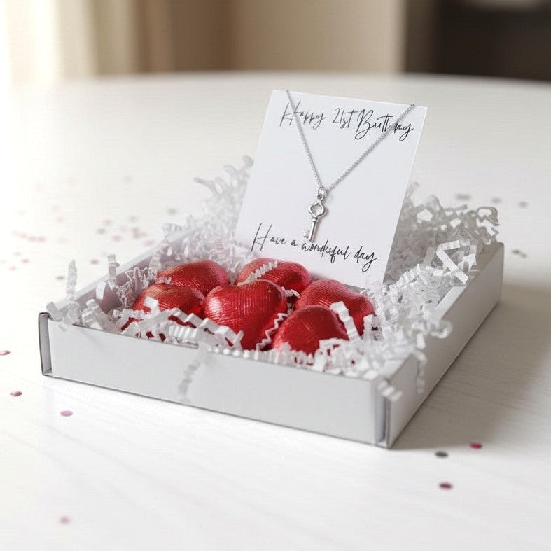 AyeDoGifts 21st birthday gift hamper with sterling silver key charm necklace and red foiled chocolate hearts.