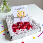 AyeDoGifts 30th birthday gift hamper with silver beaded bracelet, cubic zirconia charm, gold '30' balloon card, and red chocolate hearts.