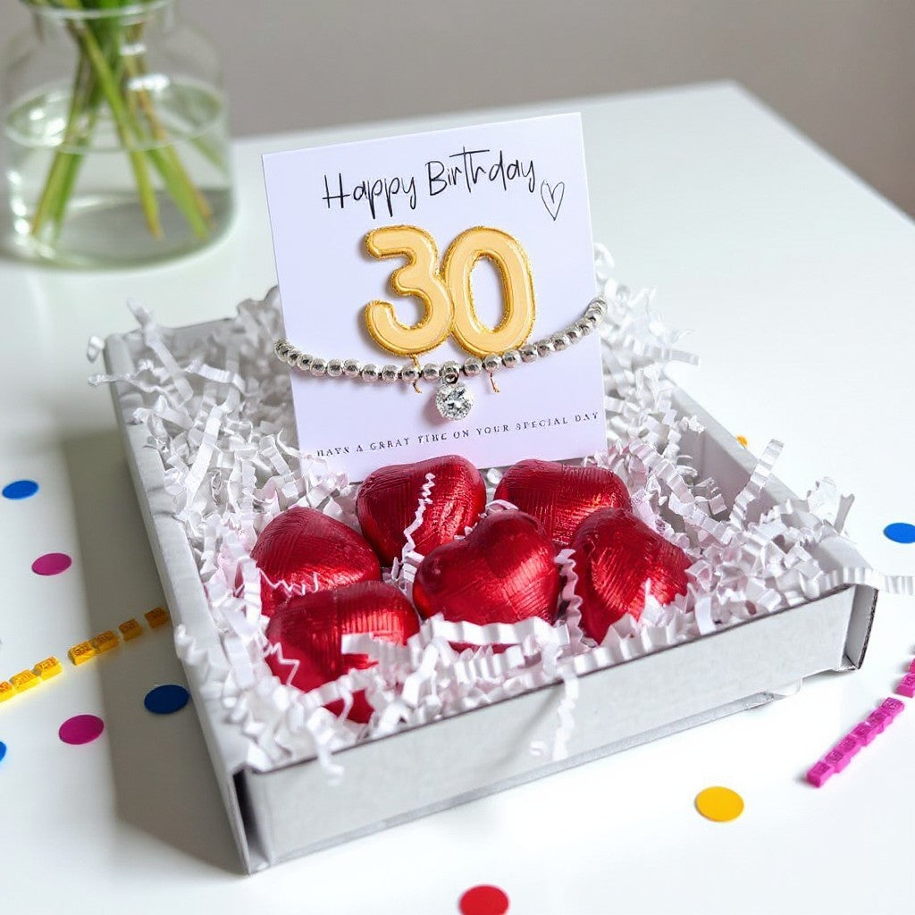 AyeDoGifts 30th birthday gift hamper with silver beaded bracelet, cubic zirconia charm, gold '30' balloon card, and red chocolate hearts.