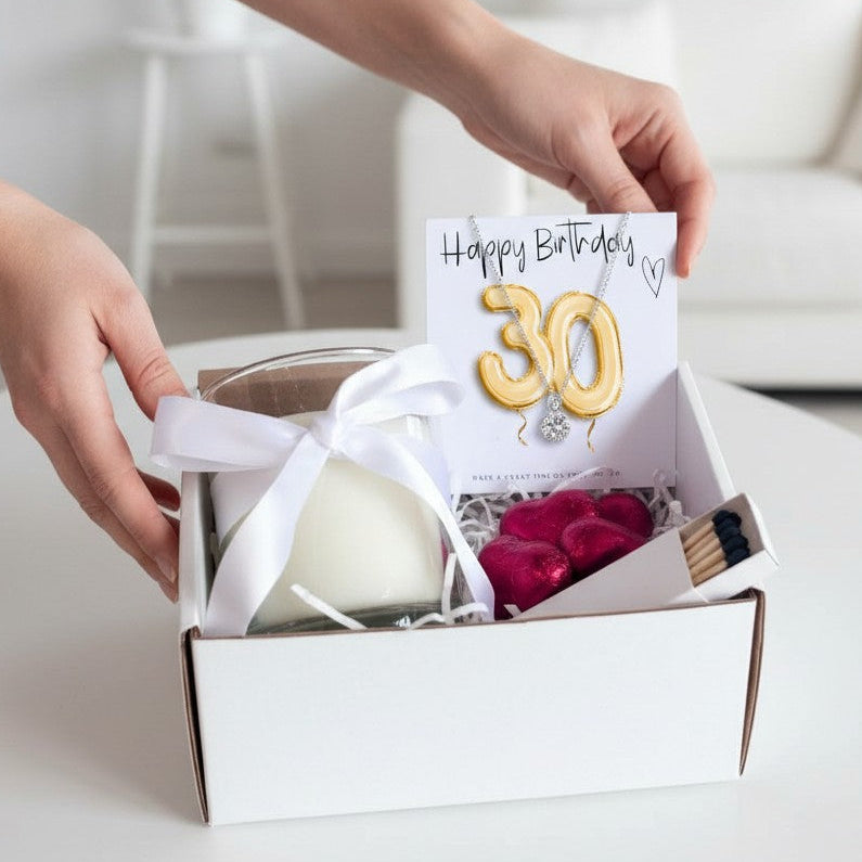 AyeDoGifts 30th birthday hamper with sterling silver necklace, vanilla candle, chocolates, and matches.