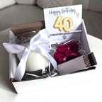 AyeDoGifts 40th birthday gift hamper with gold '40' balloon, vanilla candle, chocolate hearts, bracelet, and matches.
