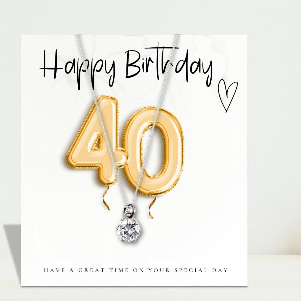 AyeDoGifts 40th birthday gift hamper with gold balloons, sterling silver necklace with cubic zirconia, vanilla candle, and chocolate hearts.