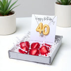 AyeDoGifts 40th birthday gift hamper with silver necklace featuring a cubic zirconia charm and gold '40' balloons on a card, plus red chocolate hearts.