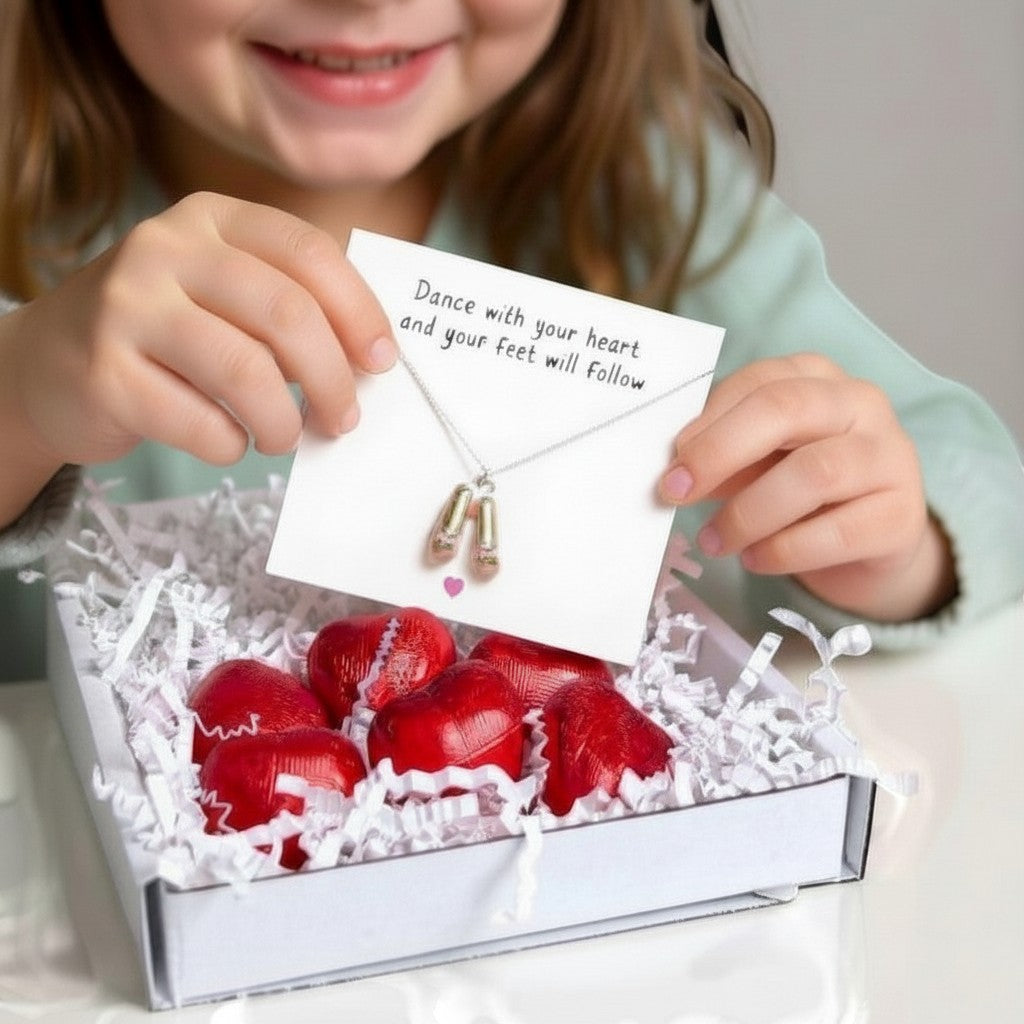 AyeDoGifts sterling silver necklace with pink enamel ballet shoes charm, presented in a gift box with chocolate hearts.