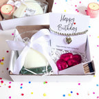 AyeDoGifts birthday hamper with silver heart bracelet, vanilla candle, milk chocolate hearts, and matches.