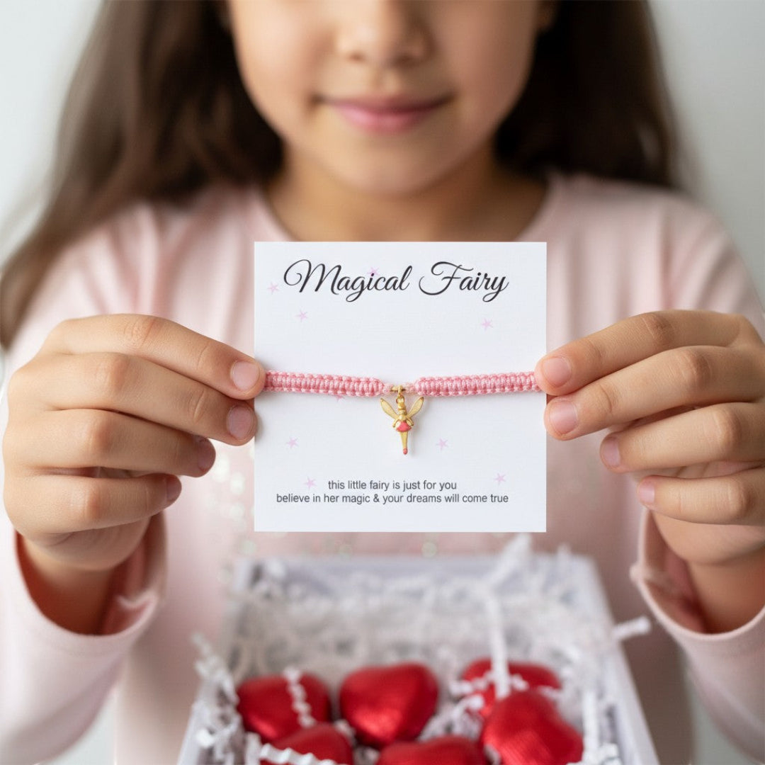AyeDoGifts pink nylon friendship bracelet with gold enamel fairy charm, presented with red foil heart chocolates.