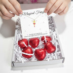 AyeDoGifts fairy necklace gift hamper for girls, featuring a gold-plated enamel fairy charm on a sterling silver chain with chocolate hearts.